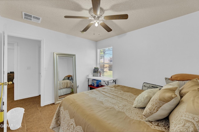 5609 Rick Husband Dr, El Paso, TX 79934 - bedroom with a textured ceiling, ceiling fan, and light tile patterned floors