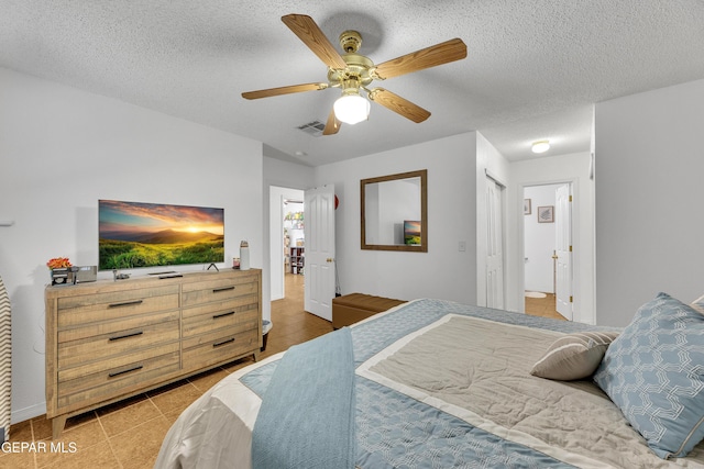 5609 Rick Husband Dr, El Paso, TX 79934 - bedroom featuring light tile patterned floors, ceiling fan, and a textured ceiling