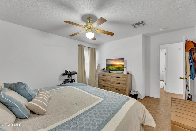 5609 Rick Husband Dr, El Paso, TX 79934 - bedroom featuring a textured ceiling, a ceiling fan, and light tile patterned floors