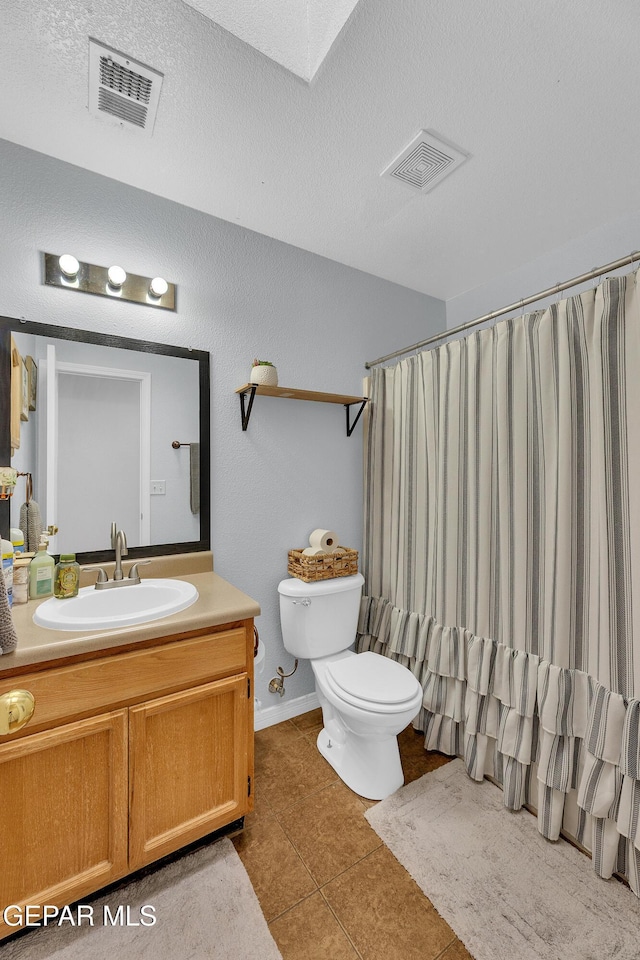 5609 Rick Husband Dr, El Paso, TX 79934 - full bathroom featuring vanity, tile patterned flooring, a shower with curtain, and a textured ceiling