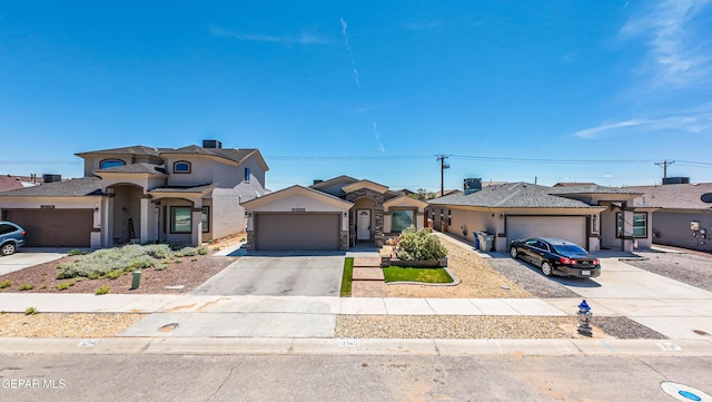 12140 Mesquite Thorn Dr, El Paso, TX 79934 - view of front facade featuring concrete driveway, an attached garage, stucco siding, and a residential view