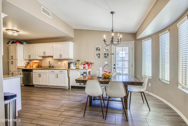 12140 Mesquite Thorn Dr, El Paso, TX 79934 - dining area with vaulted ceiling, a chandelier, and wood finish floors
