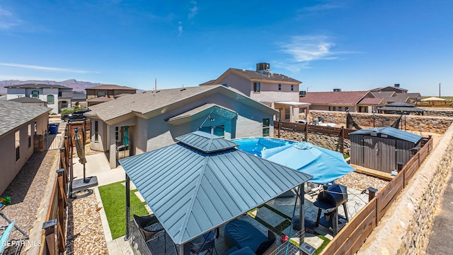 12140 Mesquite Thorn Dr, El Paso, TX 79934 - rear view of house with a standing seam roof, a residential view, a fenced backyard, and a metal roof