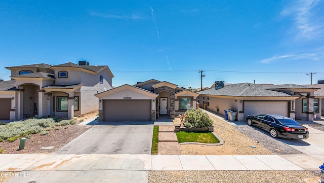 12140 Mesquite Thorn Dr, El Paso, TX 79934 - view of front facade featuring a garage, concrete driveway, stucco siding, and stone siding