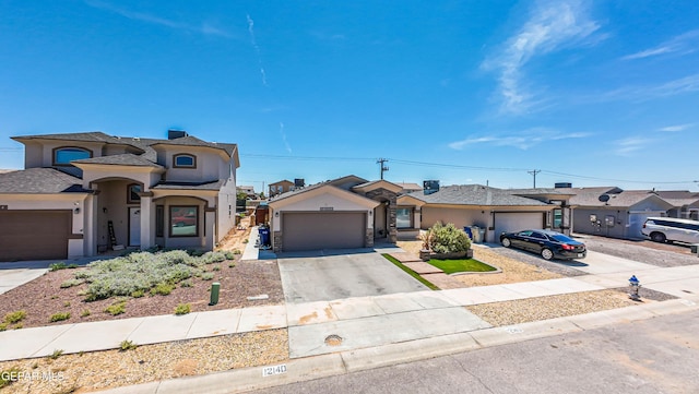 12140 Mesquite Thorn Dr, El Paso, TX 79934 - view of front of property featuring stucco siding, concrete driveway, a garage, and a residential view