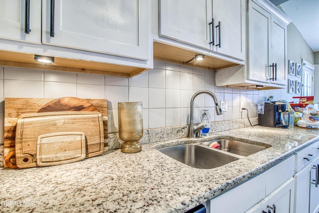 12140 Mesquite Thorn Dr, El Paso, TX 79934 - kitchen featuring tasteful backsplash and light stone counters