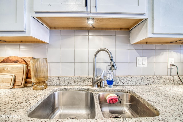 12140 Mesquite Thorn Dr, El Paso, TX 79934 - kitchen view of tasteful backsplash, white cabinets, and light stone counters