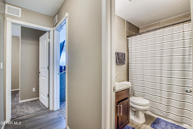 12140 Mesquite Thorn Dr, El Paso, TX 79934 - full bathroom with wood finished floors, vanity, and a shower with shower curtain