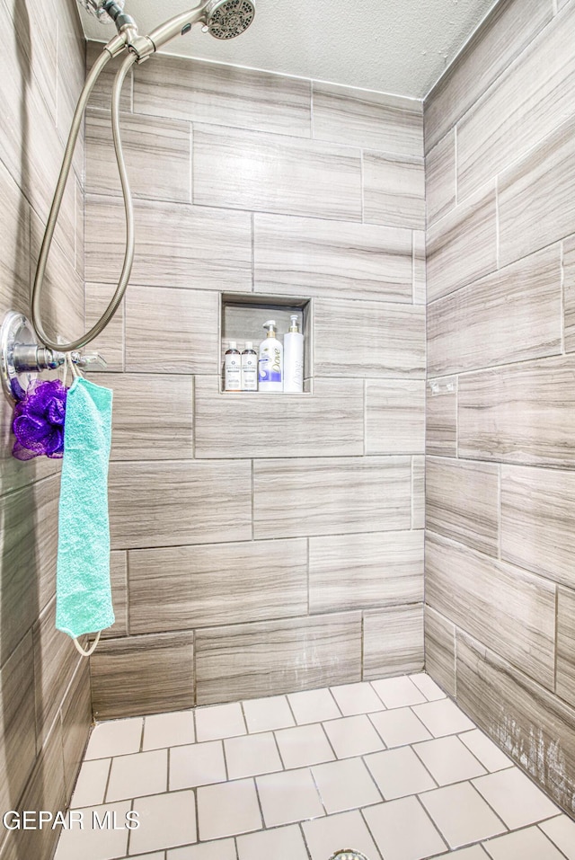 12140 Mesquite Thorn Dr, El Paso, TX 79934 - full bath with tiled shower, a textured ceiling, and tile patterned flooring
