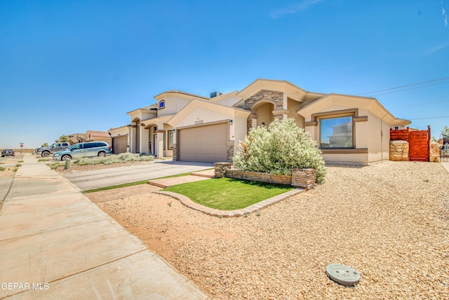 12140 Mesquite Thorn Dr, El Paso, TX 79934 - mediterranean / spanish-style home with concrete driveway, stucco siding, and an attached garage