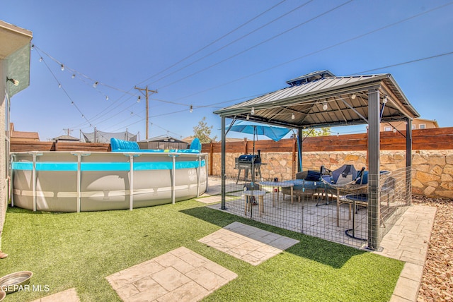 12140 Mesquite Thorn Dr, El Paso, TX 79934 - fenced backyard with a gazebo, outdoor lounge area, and a patio