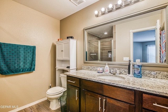 12140 Mesquite Thorn Dr, El Paso, TX 79934 - full bath with vanity, wood finished floors, and a shower stall