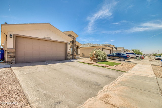 12140 Mesquite Thorn Dr, El Paso, TX 79934 - view of front of property with stucco siding, stone siding, concrete driveway, and a garage