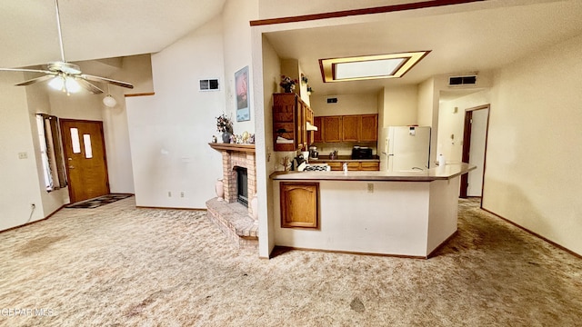 3197 Lonesome Dove Cir, El Paso, TX 79936 - kitchen featuring freestanding refrigerator, light colored carpet, a peninsula, a ceiling fan, and vaulted ceiling
