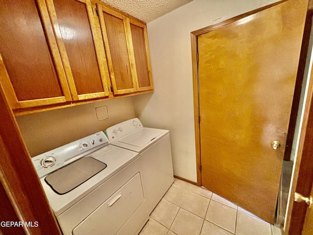 3197 Lonesome Dove Cir, El Paso, TX 79936 - laundry room featuring independent washer and dryer, cabinet space, a textured ceiling, and light tile patterned flooring