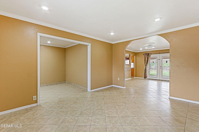 3417 Thomason Ave, El Paso, TX 79904 - unfurnished room featuring arched walkways, ornamental molding, recessed lighting, light tile patterned floors, and french doors