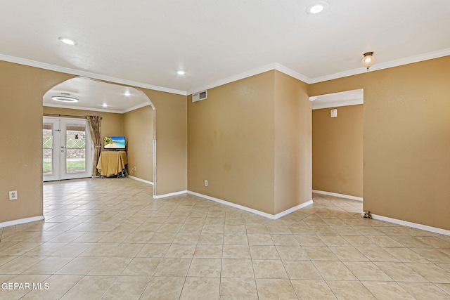 3417 Thomason Ave, El Paso, TX 79904 - spare room with arched walkways, light tile patterned floors, ornamental molding, recessed lighting, and french doors