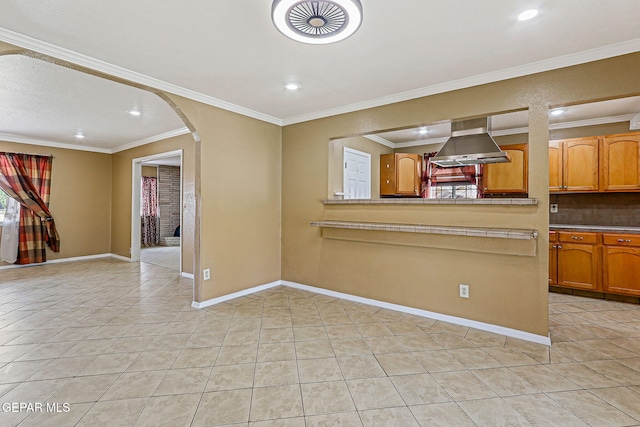 3417 Thomason Ave, El Paso, TX 79904 - kitchen featuring arched walkways, exhaust hood, light tile patterned floors, backsplash, and recessed lighting