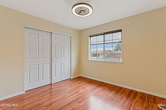 3417 Thomason Ave, El Paso, TX 79904 - unfurnished bedroom featuring wood finished floors and a closet