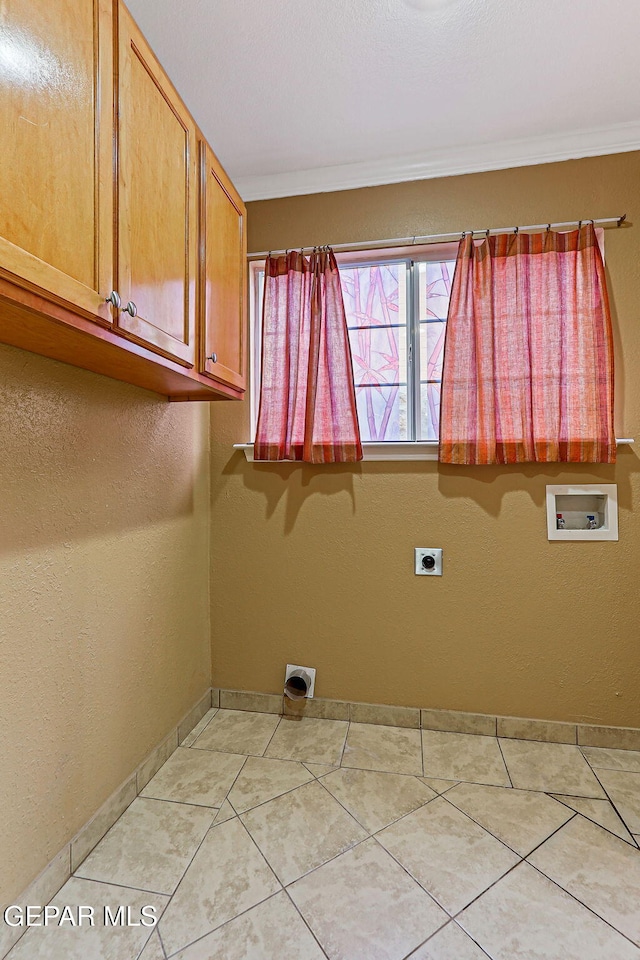 3417 Thomason Ave, El Paso, TX 79904 - washroom with hookup for a washing machine, cabinet space, electric dryer hookup, crown molding, and light tile patterned flooring