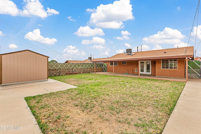 3417 Thomason Ave, El Paso, TX 79904 - fenced backyard featuring french doors, a patio, and a shed