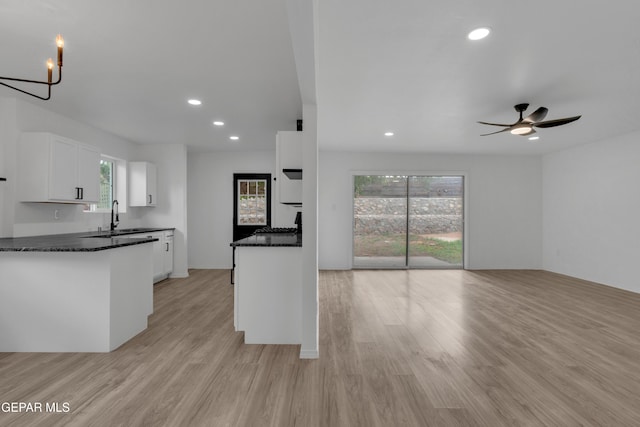 10113 Shenandoah St, El Paso, TX 79924 - kitchen with white cabinetry, light wood-style flooring, healthy amount of natural light, and recessed lighting
