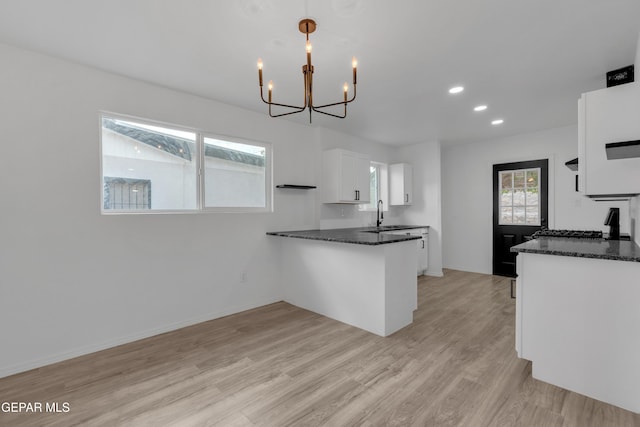 10113 Shenandoah St, El Paso, TX 79924 - kitchen with a chandelier, white cabinets, light wood-type flooring, recessed lighting, and dark stone countertops