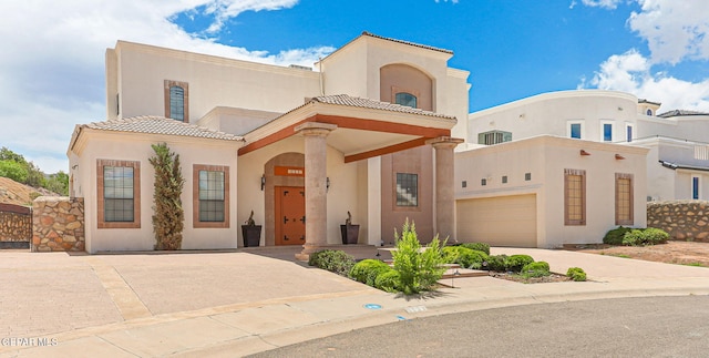 6514 Franklin Cove Place, El Paso, TX 79912 - view of front of house with stucco siding, a tiled roof, and driveway