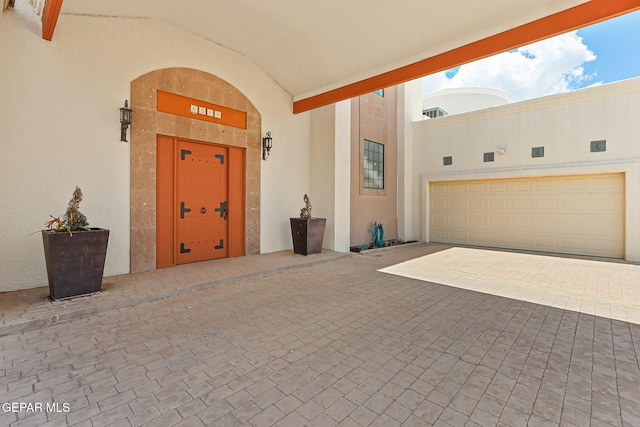 6514 Franklin Cove Place, El Paso, TX 79912 - property entrance with stucco siding, decorative driveway, and a garage