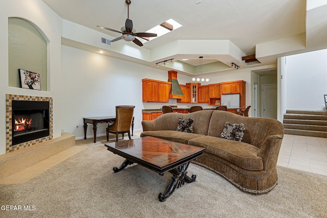 6514 Franklin Cove Place, El Paso, TX 79912 - living room featuring light carpet, a tile fireplace, stairs, and ceiling fan