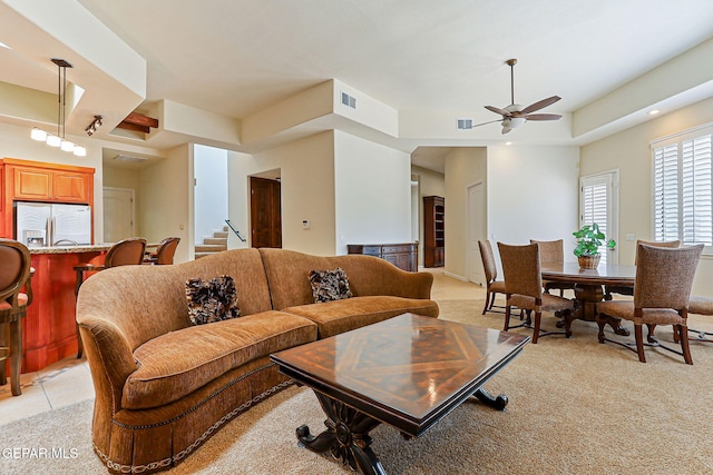 6514 Franklin Cove Place, El Paso, TX 79912 - living area featuring a ceiling fan, light colored carpet, stairway, and a tray ceiling