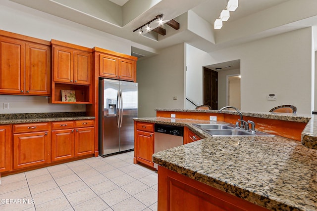 6514 Franklin Cove Place, El Paso, TX 79912 - kitchen featuring stainless steel appliances, light tile patterned flooring, brown cabinetry, and open shelves