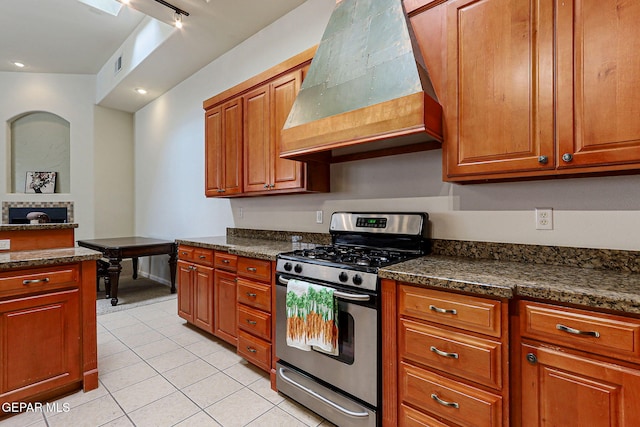 6514 Franklin Cove Place, El Paso, TX 79912 - kitchen with gas stove, premium range hood, light tile patterned floors, brown cabinetry, and recessed lighting
