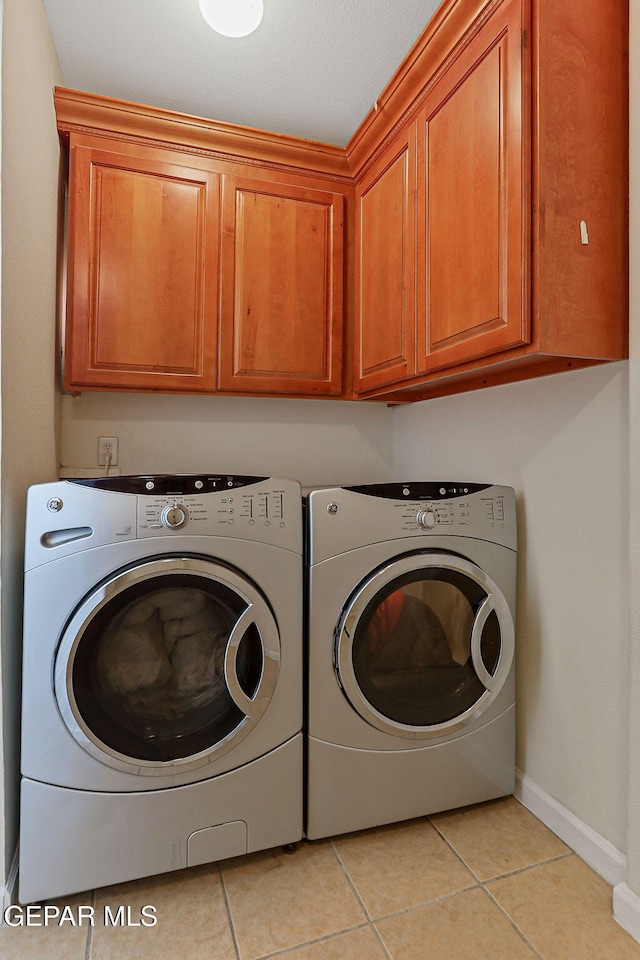 6514 Franklin Cove Place, El Paso, TX 79912 - laundry room featuring cabinet space, separate washer and dryer, and light tile patterned flooring