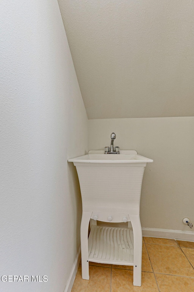 6514 Franklin Cove Place, El Paso, TX 79912 - bathroom with vaulted ceiling and tile patterned floors