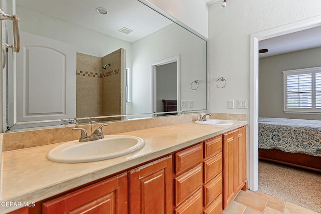 6514 Franklin Cove Place, El Paso, TX 79912 - full bath featuring double vanity, a tile shower, connected bathroom, and tile patterned flooring