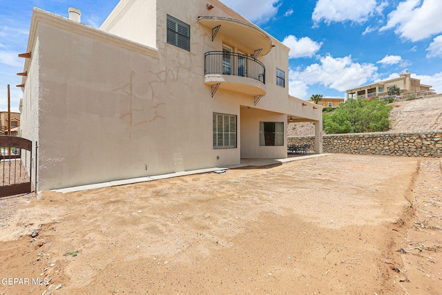 6514 Franklin Cove Place, El Paso, TX 79912 - rear view of property featuring a balcony, stucco siding, and a patio area