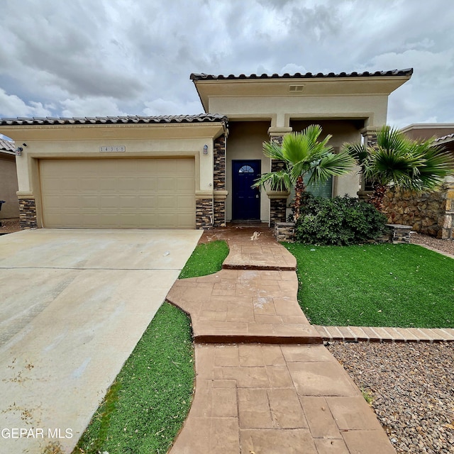 14368 Angel D Garcia Ct, El Paso, TX 79938 - view of front of house with an attached garage, driveway, stone siding, stucco siding, and a tile roof