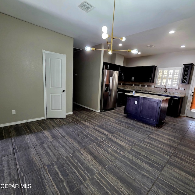 14368 Angel D Garcia Ct, El Paso, TX 79938 - kitchen featuring stainless steel refrigerator with ice dispenser, decorative backsplash, a kitchen island, decorative light fixtures, and open floor plan