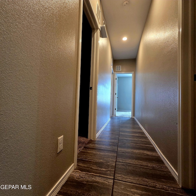 14368 Angel D Garcia Ct, El Paso, TX 79938 - hall with a textured wall, dark wood finished floors, and recessed lighting