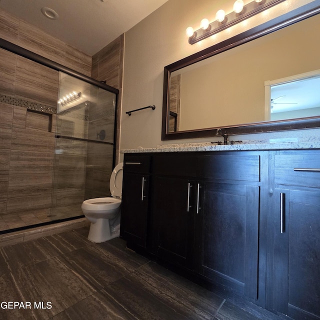 14368 Angel D Garcia Ct, El Paso, TX 79938 - bathroom with vanity, a shower stall, and wood finished floors