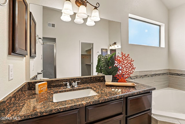 11353 W Ranch Ct, El Paso, TX 79934 - full bath with a garden tub, vanity, an enclosed shower, and a chandelier