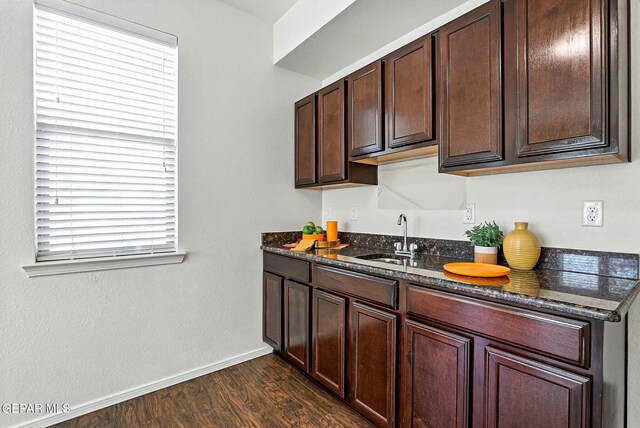 11353 W Ranch Ct, El Paso, TX 79934 - kitchen featuring healthy amount of natural light, dark stone countertops, dark wood finished floors, and dark brown cabinets