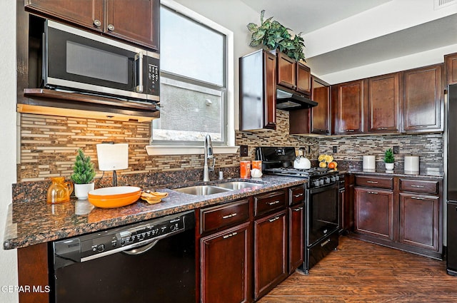 11353 W Ranch Ct, El Paso, TX 79934 - kitchen featuring black appliances, under cabinet range hood, dark wood finished floors, decorative backsplash, and dark stone counters