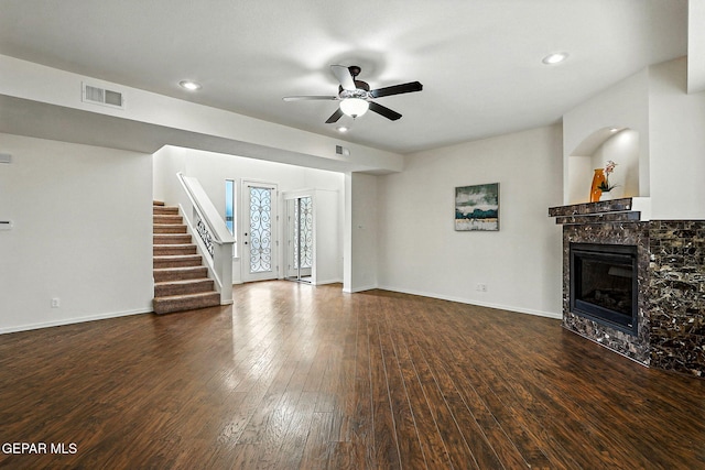 11353 W Ranch Ct, El Paso, TX 79934 - unfurnished living room featuring hardwood / wood-style flooring, ceiling fan, a glass covered fireplace, stairway, and recessed lighting