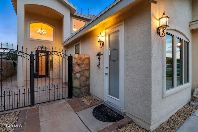 11353 W Ranch Ct, El Paso, TX 79934 - doorway to property with stucco siding and a gate