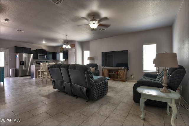 5949 Hidden Palms Dr, El Paso, TX 79924 - living area featuring a textured ceiling, ceiling fan, and a chandelier