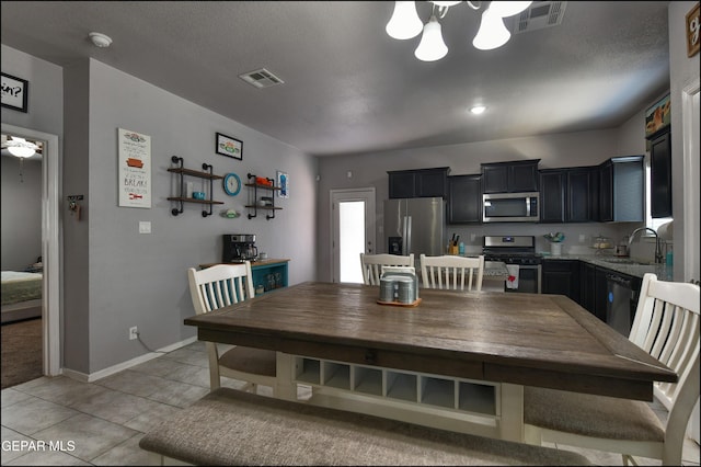 5949 Hidden Palms Dr, El Paso, TX 79924 - dining space featuring a chandelier and light tile patterned flooring