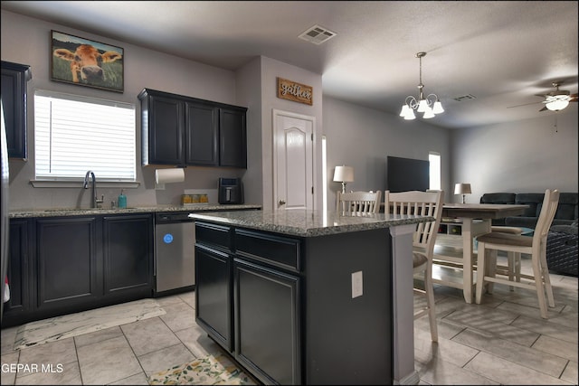 5949 Hidden Palms Dr, El Paso, TX 79924 - kitchen with open floor plan, stone countertops, a center island, a chandelier, and hanging light fixtures