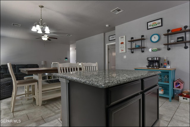 5949 Hidden Palms Dr, El Paso, TX 79924 - kitchen featuring light tile patterned floors, a chandelier, a center island, open floor plan, and a ceiling fan